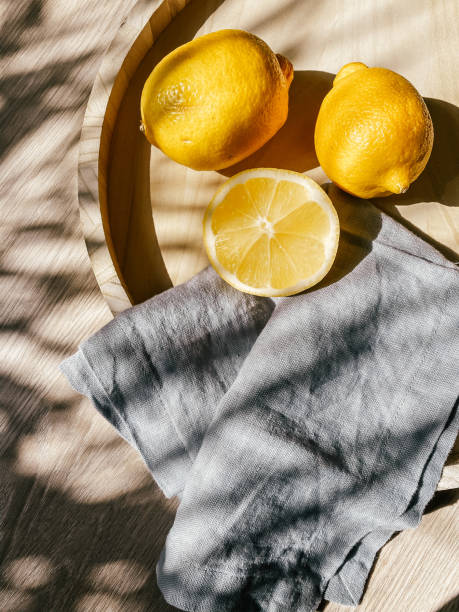 sweet Lemons on wooden tray in summer shadows