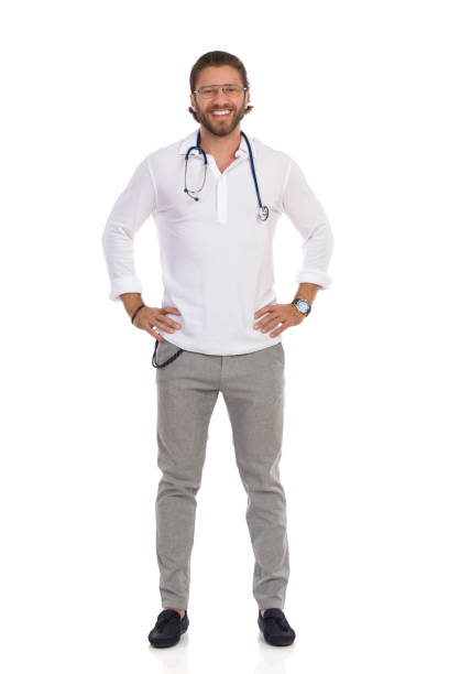 istock Smiling Handsome Male Doctor Is Standing With Hands On Hip And Looking At Camera. Front View. 1215297809
