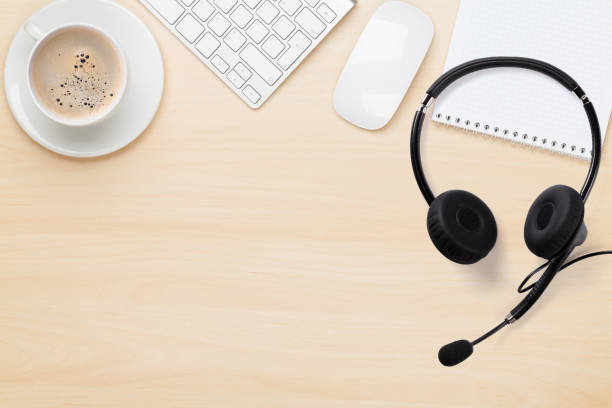 istock Office wooden backdrop with supplies and headset 1215299311