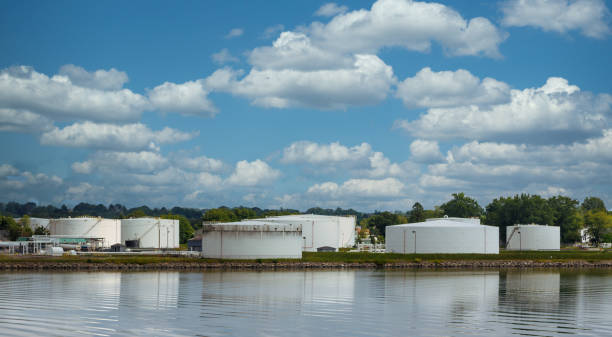 istock Old White Tanks on Shore of Calm Lake 1215302210