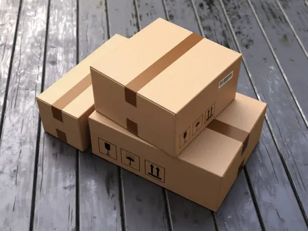 Photo of Group of cardboard boxes on black wooden porch floor