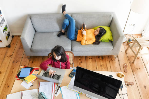 kids doing home schooling in living room