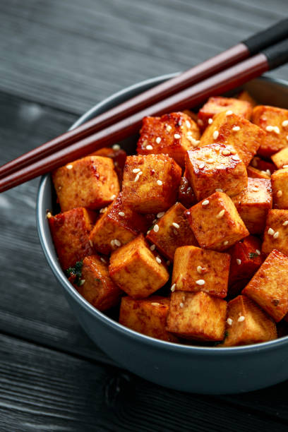 istock Fried Tofu in a bowl with chopstick and sesame seeds 1215304454