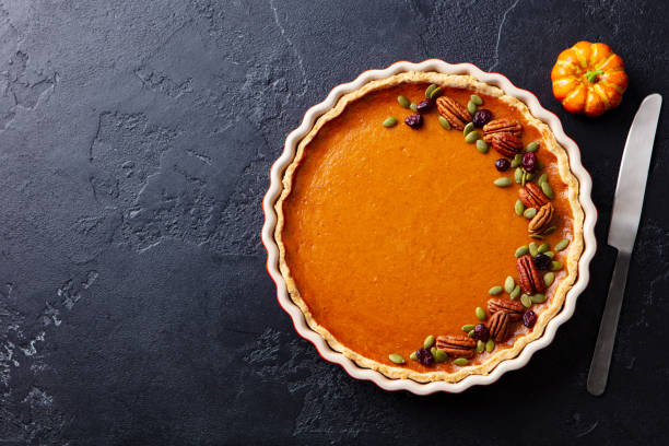 istock Pumpkin pie in baking dish. Black slate background. Copy space. Top view. 1215304941