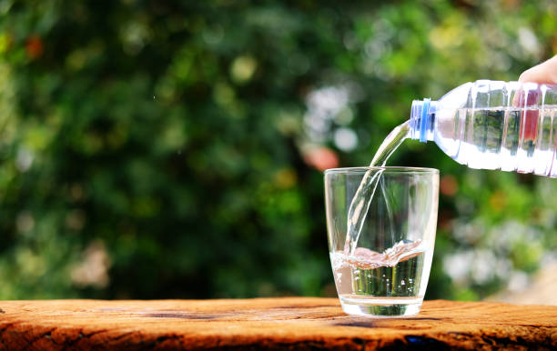 istock Water in glass on counter background 1215305547
