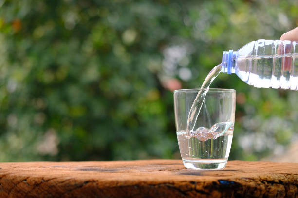 istock Water in glass on counter background 1215305573