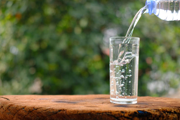 istock Water in glass on counter background 1215305786