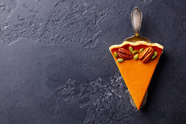 istock Pumpkin pie piece. Black slate background. Copy space. Top view. 1215305866
