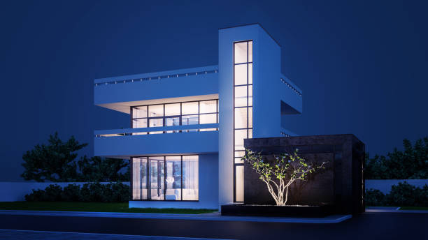 istock Modern house with white plaster with a balcony and a high staircase, in cold night light with warm light from the Windows against the background of trees and a white fence 3D stock illustration. 1215306038