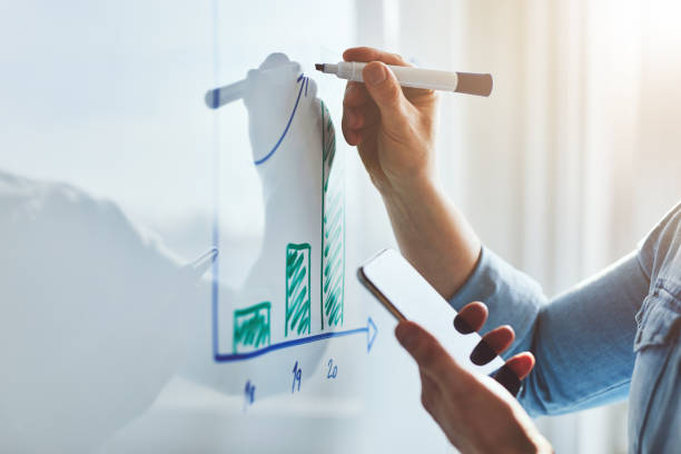 istock Man with mobile phone and marker planning website 1215307590