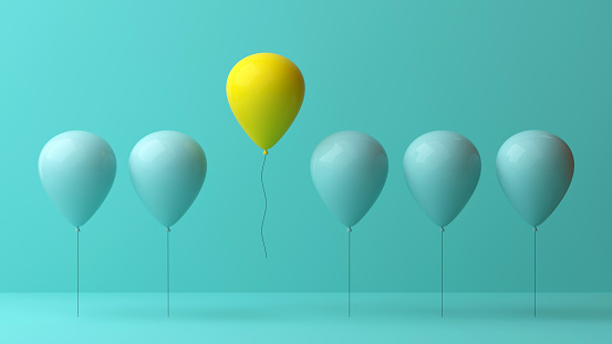 Stand out from the crowd and different concept , One yellow balloon flying away from other green balloons on light green pastel color wall background with reflections and shadows . 3D rendering