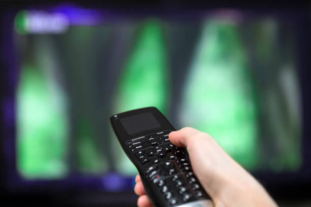 istock Woman holding tv remote 1215309249