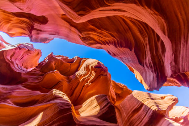 View to spectacular sandstone walls of lower Antelope Canyon in Arizona View to spectacular sandstone walls of lower Antelope Canyon narrow photos stock pictures, royalty-free photos & images