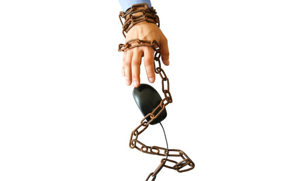 istock Man's hands in old rusty chains. Isolated on white background. In the trap of office work. Routine job. Manager near the laptop. 1215310130