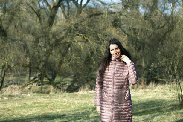 istock A girl walks through the spring park. Goes through the meadow. 1215310359