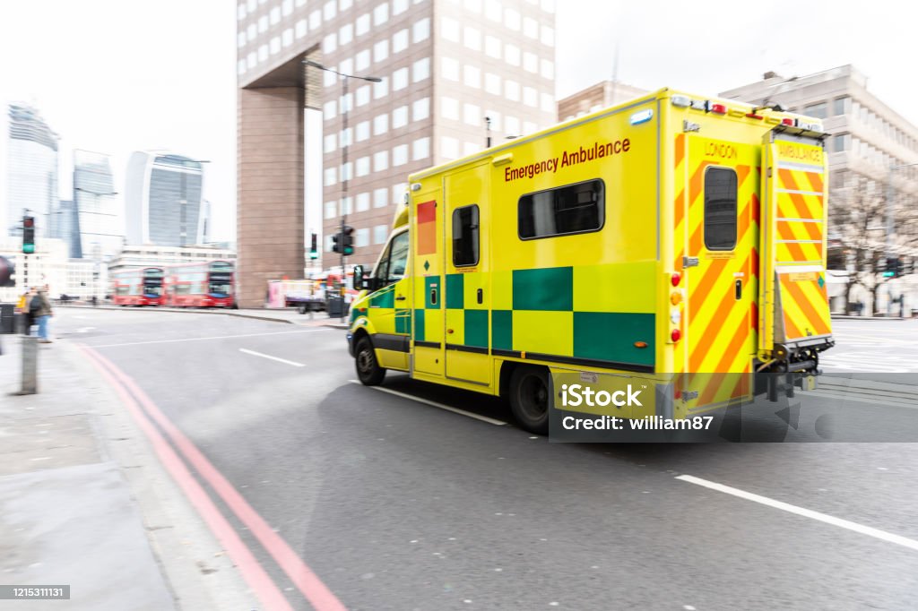Emergency ambulance in London rushing to the hospital Emergency ambulance rushing on the street with emergency lights flashing in London city centre - first aid responder at work going to the hospital - emergency, health and medical concepts Ambulance Stock Photo