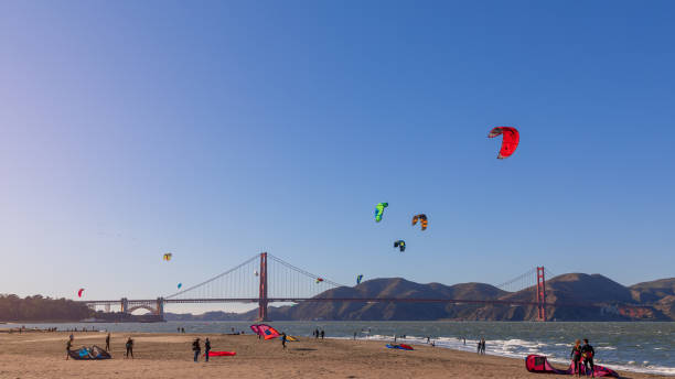 Beautiful view of San Francisco Crissy Field beach with the kitesurfers in the sea on the backplan famous Golden Gate Bridge. San Francisco - California, USA. October 27, 2019: Beautiful view of San Francisco Crissy Field beach with the kitesurfers in the sea on the backplan famous Golden Gate Bridge. airfoil photos stock pictures, royalty-free photos & images
