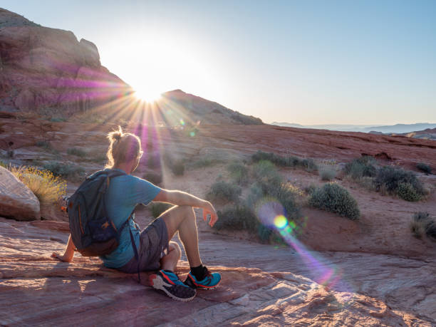 istock Hiker man contemplating red sandstone at sunrise 1215312549