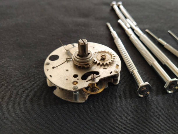 watch mechanism. clockwork mechanism and small screwdrivers watch mechanism. clockwork mechanism and small screwdrivers broken pocket watch stock pictures, royalty-free photos & images