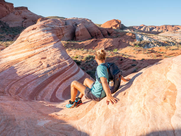 istock Hiker man contemplating red sandstone 1215312703