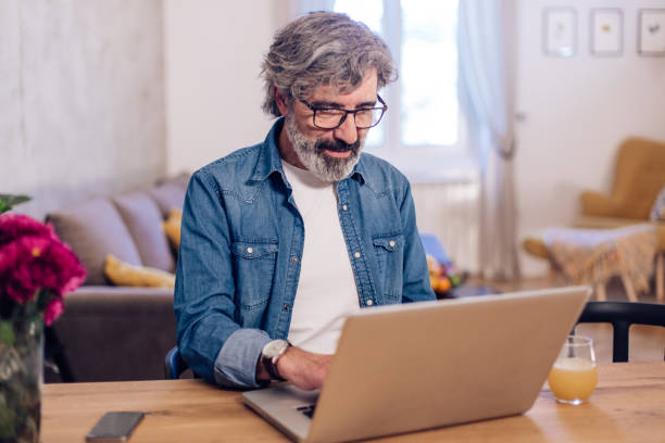 istock Mature man working from home during the COVID-19 lockdown 1215312770