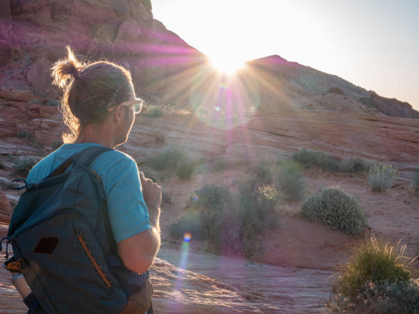 istock Hiker man contemplating red sandstone at sunrise 1215313579