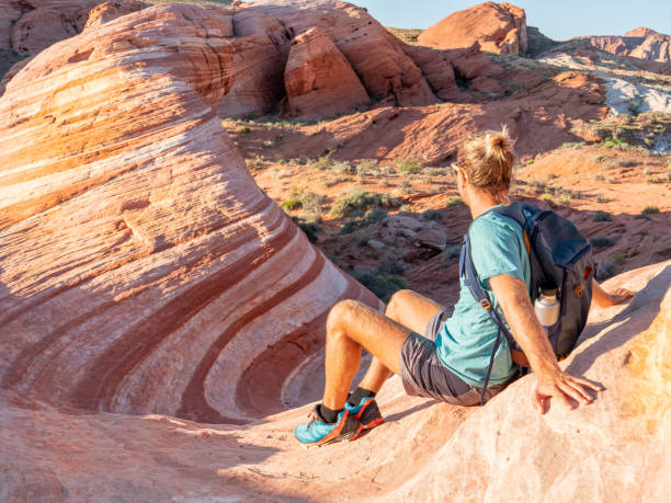 istock Hiker man contemplating red sandstone 1215313666