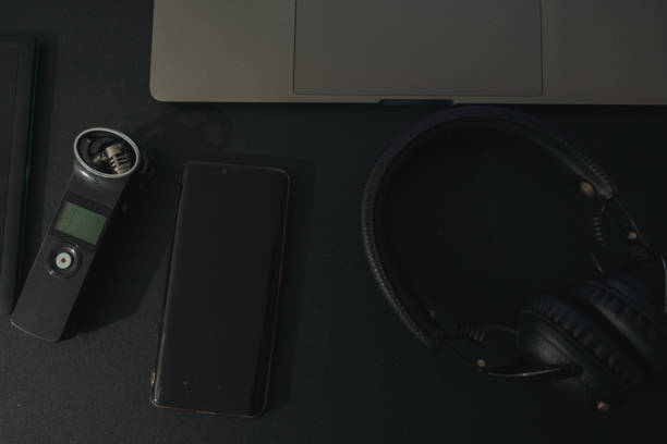istock Business workspace for international journalism with microphone, laptop, cell phone and headphones. 1215314376