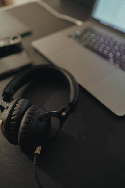 istock Business workspace for international journalism with microphone, laptop, cell phone and headphones. 1215314545