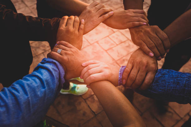 istock Group of young  people Hands Together with a partnership team Joining Concept 1215314705