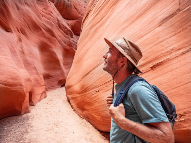 istock Young man walking inside Antelope Canyon, USA 1215315686