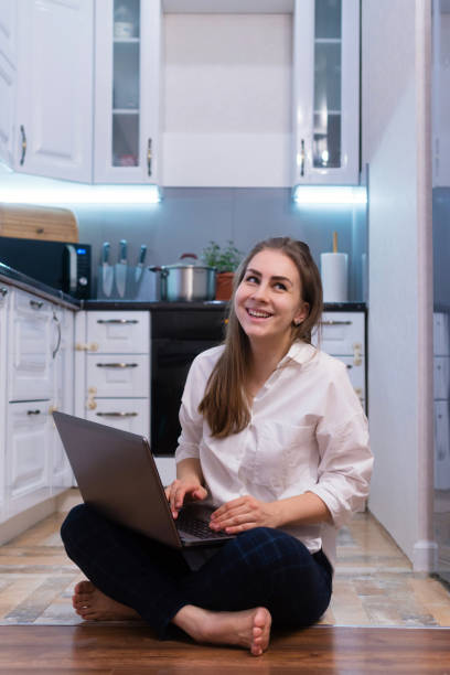 istock Girl in kitchen with laptop 1215317097