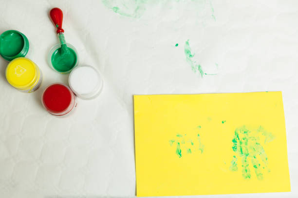 istock paints and paintbrush on a table next to cardboard to do a children's activity 1215317404