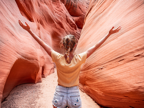 Cheerful young woman inside of Antelope Canyon in Arizona, USA
People travel nature concept