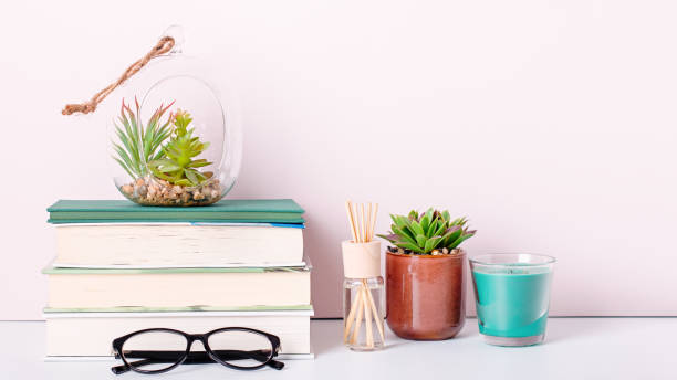 istock Books stack, eyeglasses, house plants succulents and fragrant candle and sticks. Background for World Book Day. Still life with stack of colorful books and home interior decor 1215318879