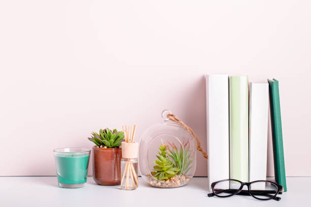 istock Books stack, eyeglasses, house plants succulents and fragrant candle and sticks. Background for World Book Day. Still life with stack of colorful books and home interior decor 1215318988