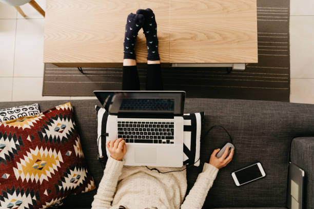 istock Young woman working from home sitting on the sofa 1215319694