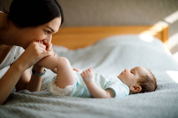 istock Happy mother playing with her baby 1215319998