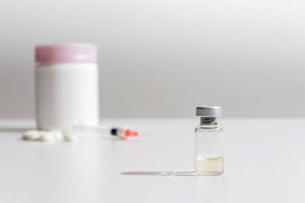 istock Coronavirus ampoule vaccine on hospital light background. 1215320044