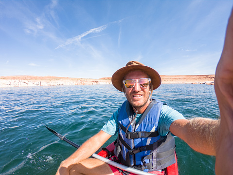 Young man canoeing take selfie on beautiful lake in canyon
People travel outdoor activity vacations concept
