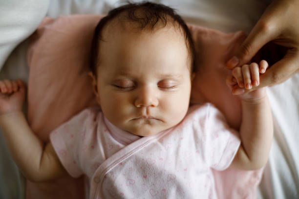 istock Newborn baby holding mother's hand 1215320282