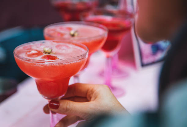 istock Fresh pink cocktail with strawberry in drink glass 1215320364