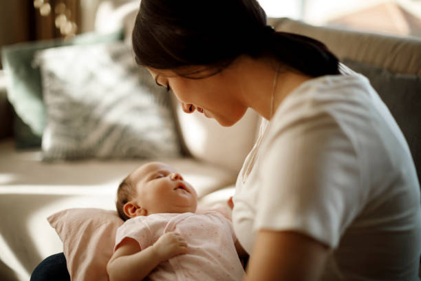 istock Mother holding her sleeping baby girl 1215320558