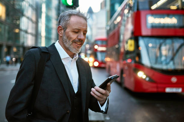 istock Mature Caucasian Businessman Checking Smart Phone After Work 1215321216