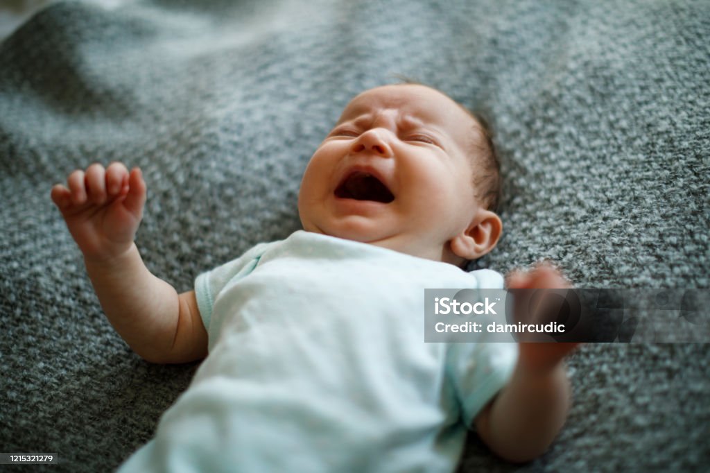 Newborn baby girl crying Baby - Human Age Stock Photo