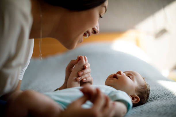 istock Happy mother playing with her baby 1215321385