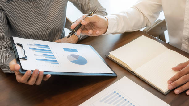 istock Business team brainstorming and discussing with financial data and report graph. Teamwork meeting working concept. 1215323036