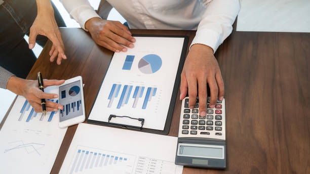 istock Business team brainstorming and discussing with financial data and report graph. Teamwork meeting working concept. 1215323044