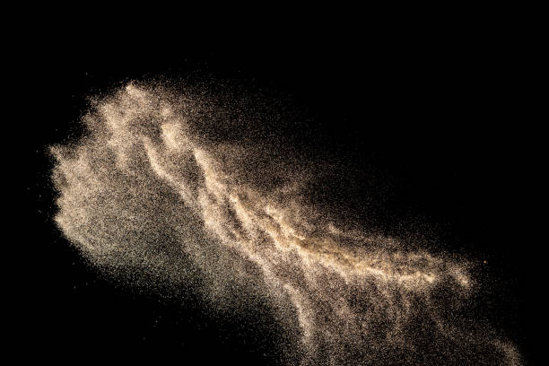 istock Brown colored sand splash.Dry river sand explosion isolated on black background. Abstract sand cloud. 1215323479