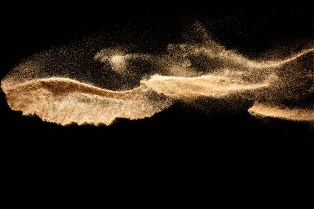 istock Brown colored sand splash.Dry river sand explosion isolated on black background. Abstract sand cloud. 1215323481